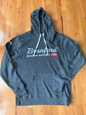 J. America Charcoal Hooded Sweatshirt with Branford Building Supplies Logo